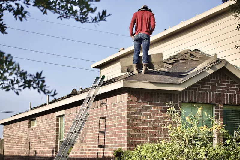 Professional roofer working on a residential roof in Crozet